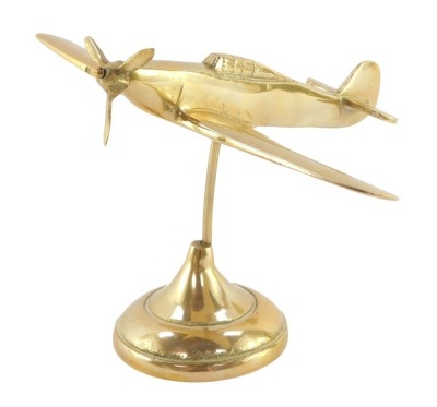 A brass aeronautical desk stand, modelled as a Hurricane fighter plane, 19cm wide.