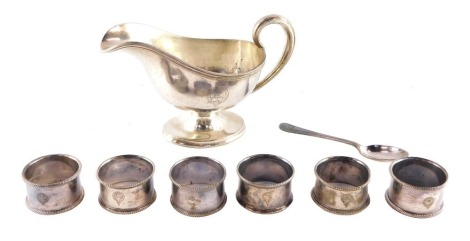 A Pacific Steam Navigation Company silver plated sauce boat, by Elkington & Company together with a teaspoon and six napkin rings, numbers 93, 17, 30, 41, 13 and one unnumbered.