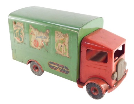 A Tri-ang tin plate transport van, number 200, with a red cab and green covered wagon, bearing advertising labels, registration LB2121, 48cm wide.