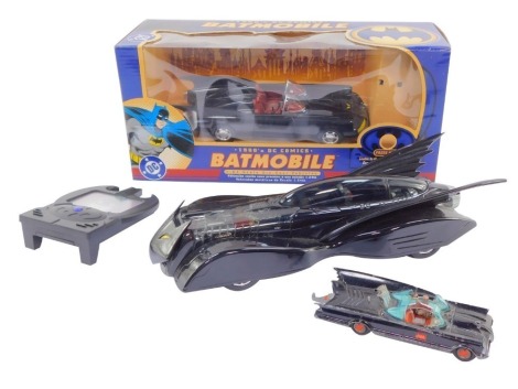 A Corgi die cast 1960's DC Comics Batmobile, scale 1:24, boxed, together with a further Batmobile 2000, a Batman Communicator, and a further earlier die cast Batmobile, Batman lacking. (4)