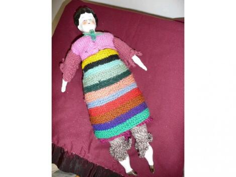 A charming little vintage style doll with knitted clothes