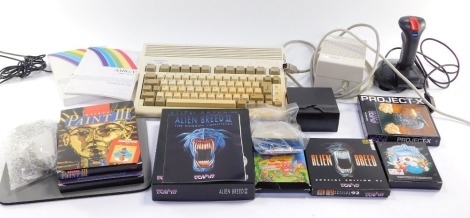 A Commodore Omega A600 computer, with instruction booklets, quick shot game controller and assorted games, including Project-X, Push Over, Silly Putty, and Alien Breed.