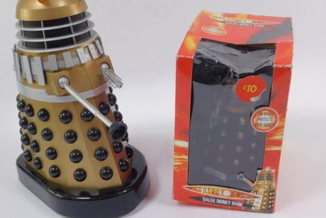 A Product Enterprise battery operated Gold Supreme Dalek, together with a Dr Who Dalek money bank. (2)