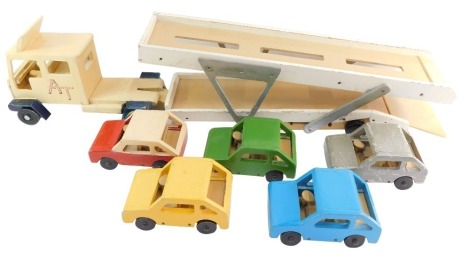 A scratch built painted wooden model of a car transporter, together with five cars. (6)