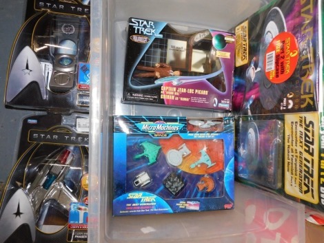 A Playmates Star Trek Star Fleet Communicator, phaser, Captain Jean Luc Picard and Quinan, Micro Machines Next Generation limited edition collector's set, and a Star Trek Next Generation Part Two magazine and collector's edition DVD.