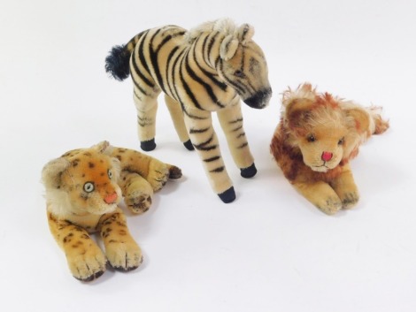 Three stuffed toy animals, possibly Steiff, comprising a zebra, recumbent lion and a recumbent leopard. (3)