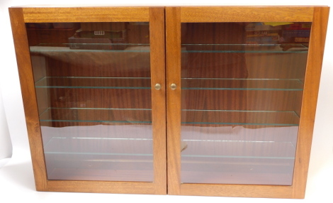 A mahogany two door collector's cabinet, with four glass shelves, 65cm high, 95cm wide, 16.5cm deep.