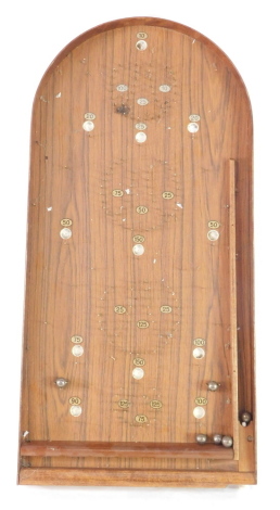 A vintage bagatelle game, with six balls.