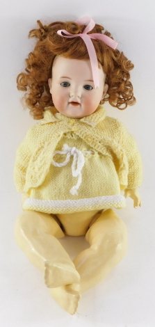 An Armand Marseille bisque head doll, no.990, A4M, modelled with blue eyes, open mouthed.