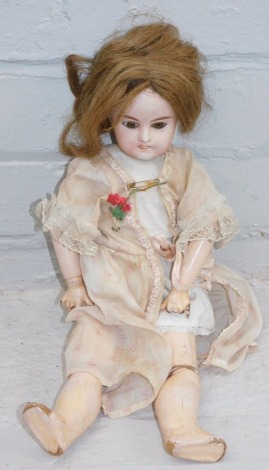 A bisque porcelain figure of a doll, on papier mache body, the head stamped Paris EHLRI and numbered 4, in flowing dress.