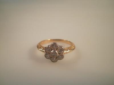 A seven stone diamond floral cluster ring