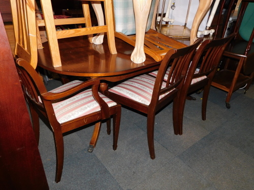 A reproduction mahogany dining table, together with five chairs. (6) The upholstery in this lot does not comply with the 1988 (Fire & Fire Furnishing) Regulations, unless sold to a known exporter or upholsterer it will be cut from the frame before leaving