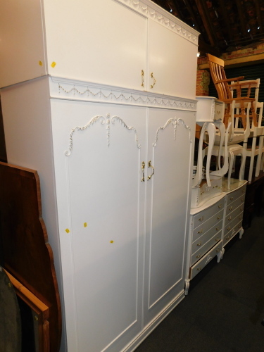 A French style cream painted bedroom suite, comprising two dressing tables and stools, two chests, wardrobe and two bedside cabinets. (9)