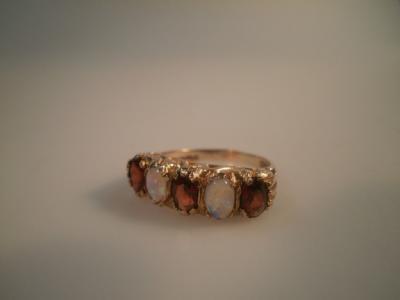 A garnet and opal set dress ring in 9ct gold