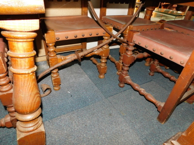 A Spanish pine dining table, with turned and splayed legs, with central iron stretcher, together with six chairs with bobbin turned back rests. (7) - 2