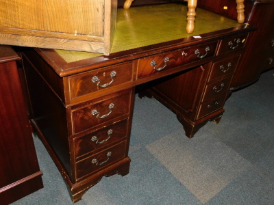 A reproduction mahogany pedestal desk, with green tooled leather insert.