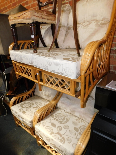 A bamboo three piece conservatory suite, upholstered in gold and cream brocade.