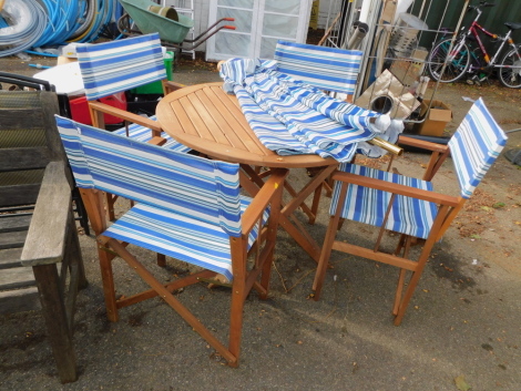 A teak folding garden table, four directors style chairs and a matching parasol. (6)