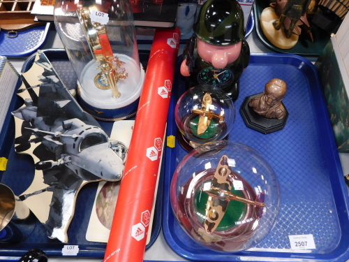 A group of military related items, to include two glass models of Spitfires, in domed case, and a Ross Army battery operated mantel clock, model of an airman, War Plane Collector's Clubs Edition Models, Astra domed anniversary type clock, etc. (2 trays)