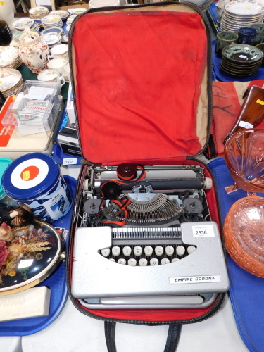 An Empire Corona cased typewriter.