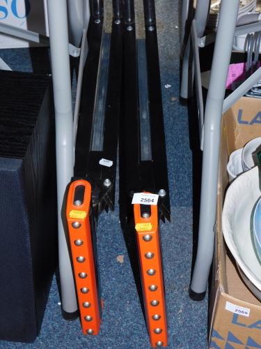 A pair of folding stands with rollers.