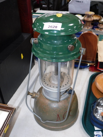 A military carrying lantern, with green enamelled top, on tin base numbered 129-8558.