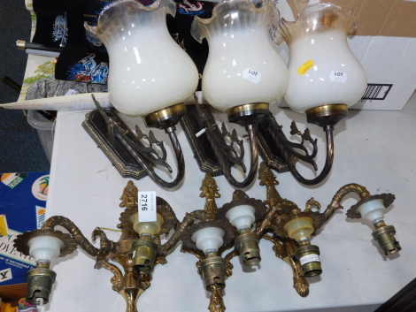 Wall lights, to include a set of three two branch gilt metal wall sconces, two single chrome finish and glass shaded wall lights, and a Tiffany style lamp shade. (7)