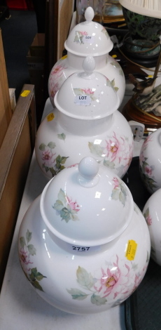 Three Caverswall porcelain vases and covers decorated with blossom.