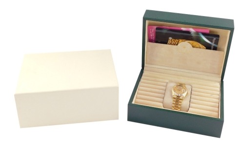 A Rolex gentleman's 18ct gold cased Oyster Perpetual day-date wristwatch, circular gold dial baring Roman numerals, date and day apertures, centre seconds, superlative chronometer, on an 18ct gold bracelet strap, cased and outer boxed.