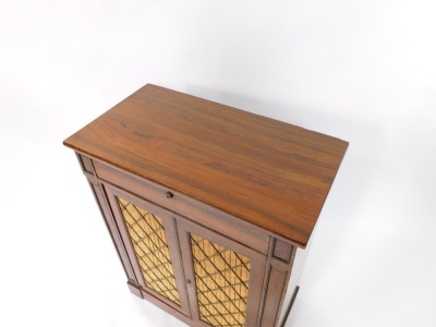 A Regency rosewood secretaire chiffonier, the secretaire drawer opening to reveal a tooled leather ratchetted writing slope flanked by a pen tray and recesses for ink wells and writing accoutrements, above a pair of doors with brass grilled silk fabric ba - 2