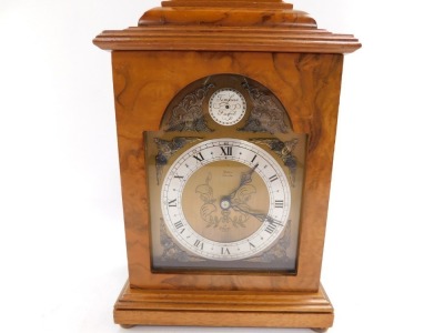 An Elliott mid century walnut cased mantel clock, break arch tempus fugit dial, with chapter ring bearing Roman numerals, clockwork movement, the case of conventional form, with brass carrying handle, raised on brass bun feet, for Usher of Lincoln, 30cm h - 2