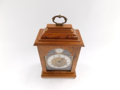 An Elliott mid century walnut cased mantel clock, break arch tempus fugit dial, with chapter ring bearing Roman numerals, clockwork movement, the case of conventional form, with brass carrying handle, raised on brass bun feet, for Usher of Lincoln, 30cm h - 3