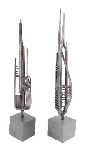 A pair of modern metal sculptures, raised on serpentine bases, 27cm and 30cm high.