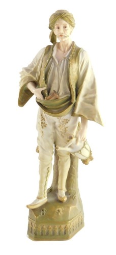 An Ernst Wahliss blush porcelain figure, late 19thC, of an Ottoman gentleman, raised on a naturalistic base, 32.5cm high.