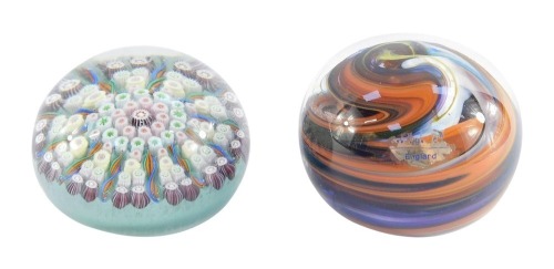 A concentric millefiori glass paperweight, 7cm diameter, together with a Wedgwood glass paperweight with swirl decoration, 7cm diameter. (2)