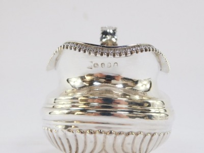 A George III silver cream jug, of semi fluted form, raised on four ball feet, London 1818, 5.10t oz.. - 4