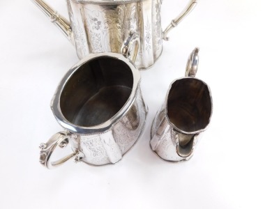 A Victorian silver plated three piece tea set, with foliate scrolled engraving, oval reserve, monogram engraved, comprising teapot, cream jug and sugar bowl. - 2