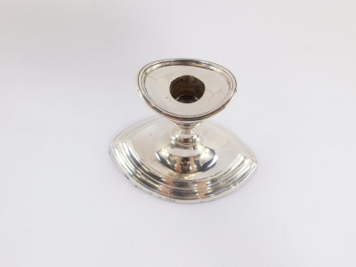 A George V silver candlestick of elliptical form raised on a stepped base, Chester 1913, 10.5cm high, 9.0toz all in. - 2