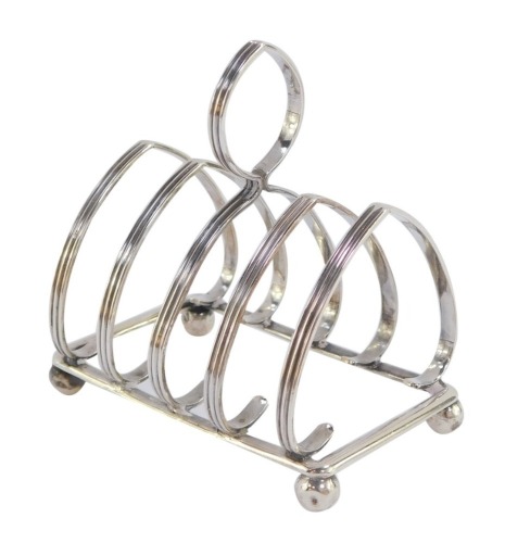 A George V silver four division toast rack, raised on ball feet, W Hutton &Sons Ltd, Birmingham 1914, 1.5toz.