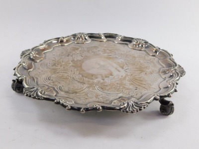 A Victorian silver plated salver, for Thomas's of Bond Street, engraved centrally with a crest within a floral and foliate surround, gadrooned border, raised on three scroll feet, etched marked, 26.5cm diameter. - 2