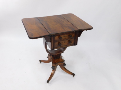 A Regency rosewood drop leaf work table, with two frieze drawers, raised on a U shaped support, over a quatrefoil base above out swept legs, brass paw capped on castors, 75cm high, 36cm wide, 72.5cm extended, 56cm deep. - 2