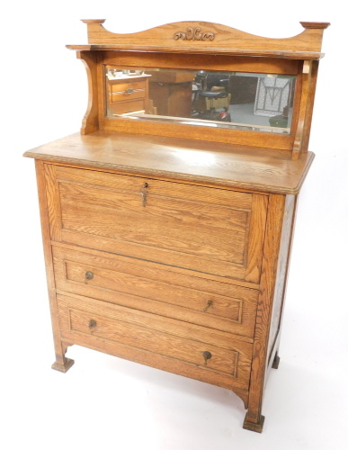 A Victorian Art Nouveau mirror back sideboard, with a drop flap opening to reveal a single shelf, over two frieze drawers, raised on block feet, 148cm high, 101cm wide, 48cm deep.