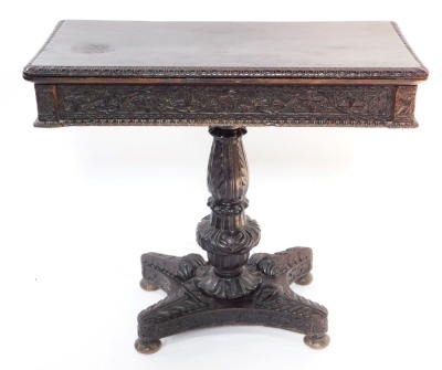 A Victorian stained oak fold over card table, with a vine carved frieze, over an urn and fluted column carved with acanthus leaves, on a quatralobe base carved with leaves, raised on bun feet, 50cm high, 90cm wide, 45cm deep.