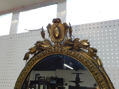 A Victorian gilt wood and gesso oval girandole, with shield and leaf surmount, having three scrolling candle holders, 89cm high, 54.5cm wide. - 2