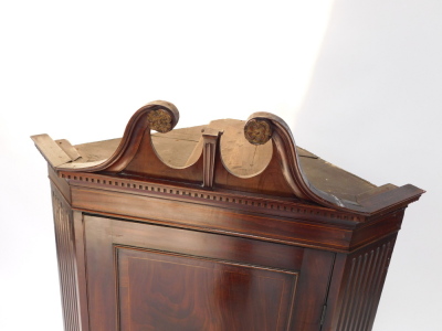 A Georgian style mahogany and boxwood line inlaid hanging corner cupboard, early 20thC, the broken neck pediment, above dentil moulding over a paneled door, opening to reveal three shaped shelves, flanked by channeled sides, 125cm high, 81cm wide, 48cm de - 2