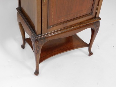 An Edwardian mahogany and inlaid side cabinet, with a single panelled door opening to reveal two shelves, over leaf carved cabriole legs united by a shaped under tier, 94.5cm high, 51cm wide, 36cm deep. - 3