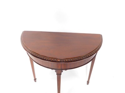 A Victorian style mahogany demilune fold over card table, raised on square tapering legs and spade feet, 55cm high, 76cm wide, 39.5cm deep. - 2