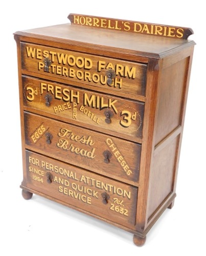 An early 20thC oak chest, of four long drawers, later painted with Horrell's Dairies, Westwood Farm, Peterborough, together with details of items sold and contact information, raised on bun feet, 106cm high, 86cm wide, 45cm deep.