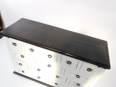 A black and white painted kitchen chest, with an arrangement of thirteen long and deep short drawers, each with black ringed handles, raised on a plinth base, 83cm high, 201cm wide, 43.5cm deep. - 2