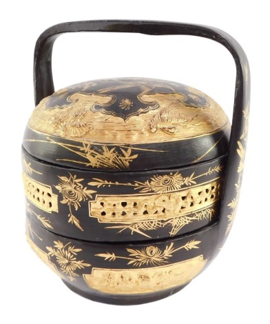 A Chinese black and gilt lacquer tiffin box, of cylindrical form, decorated with birds and blossom, 26cm high.